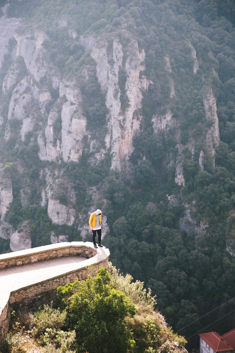 Free Image of A hiker standing on the edge of a viewing platform in Montserrat 
