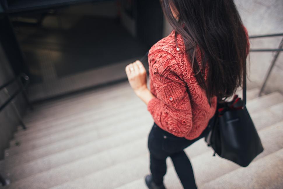 Free Image of A young brunette descending stairs 