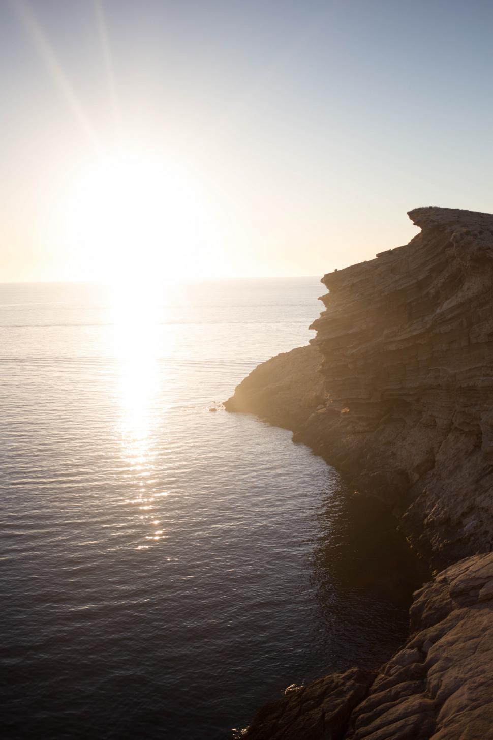 Free Image of A rocky seashore at sunset 