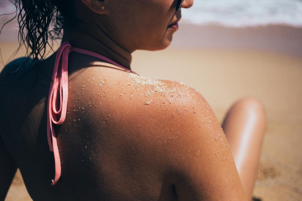 Free Image of Sandy shoulder of a caucasian woman on the beach 