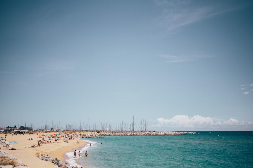 Free Image of Panoramic view of a Spanish beach with tourists 