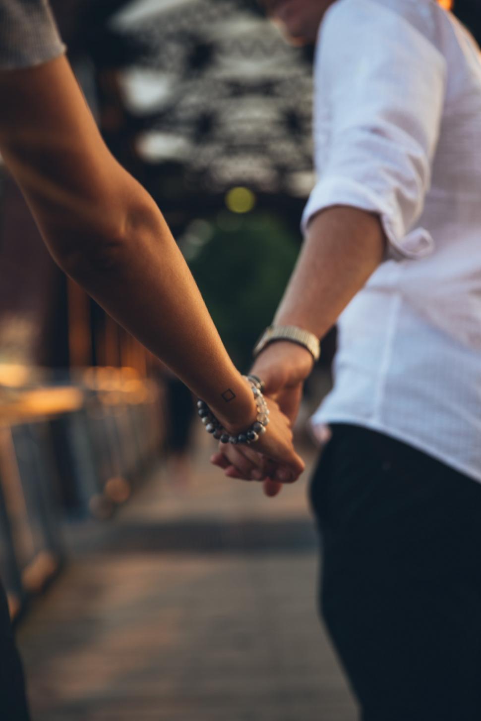 Download Free Stock Photo of A young caucasian couple holding each other s hands 