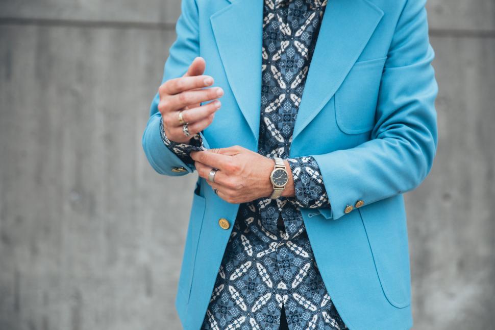 Free Image of A young caucasian man wearing turquoise blue jacket posing outdo 