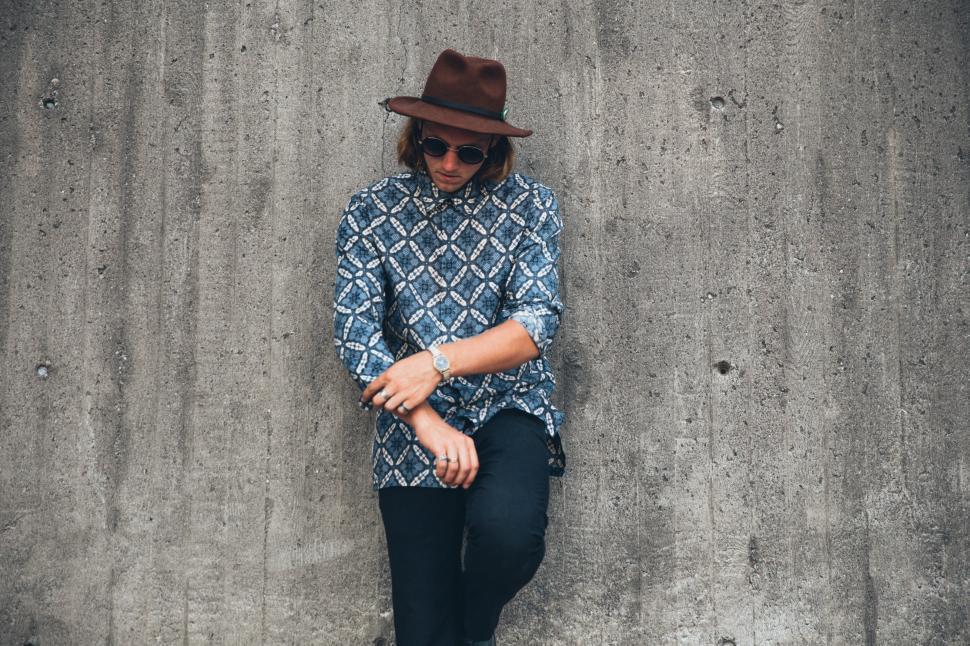 Free Image of A young caucasian man wearing patterned shirt posing outdoors 