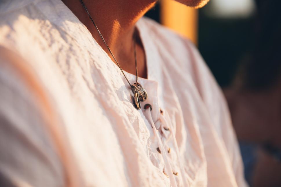 Free Image of A young man wearing ring in a necklace 