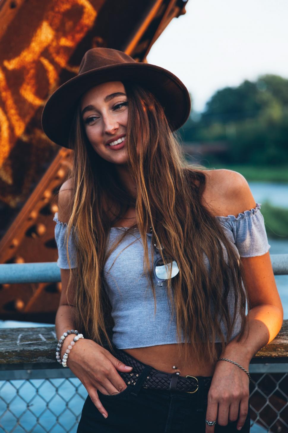 Free Image of A young caucasian woman smiling at sunset 