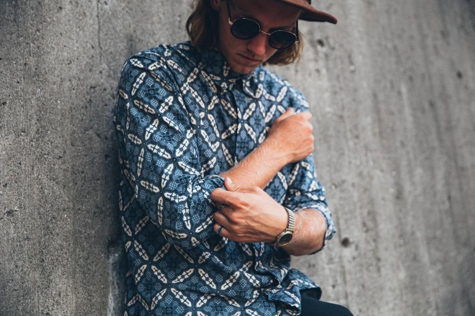Free Image of A young man wearing patterned shirt posing outdoors 