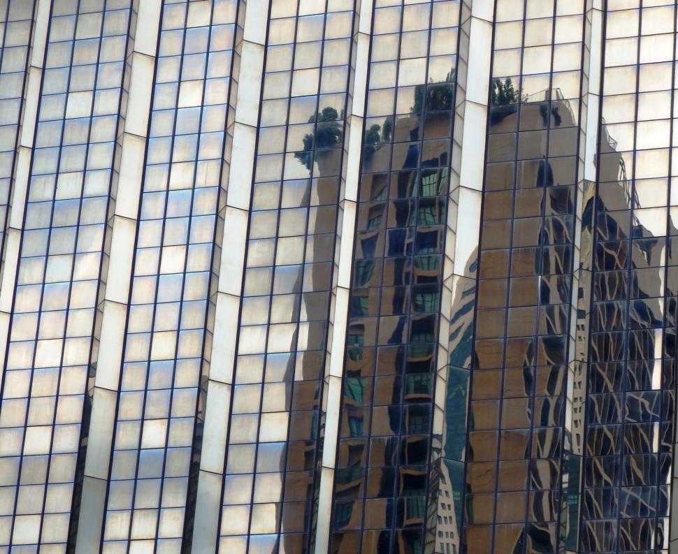 Free Image of Abstract high-rise building reflection in the glass facade of a modern skyscraper  