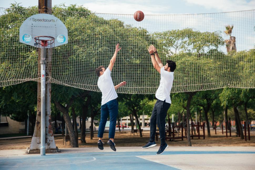 Download Free Stock Photo of Two young men playing basketball 