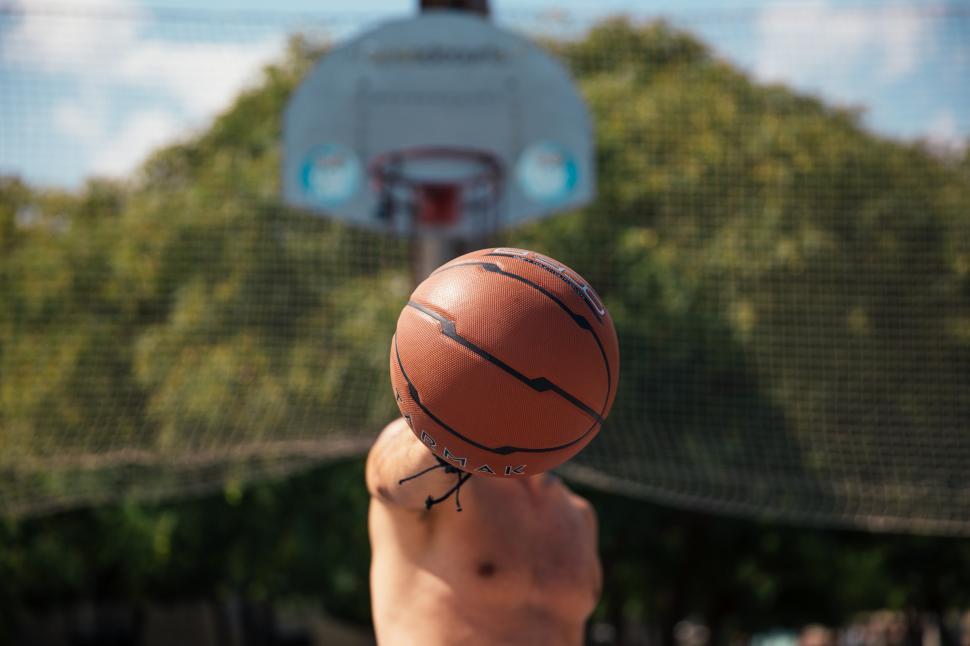 Free Image of A young man holding a basketball in his hand 