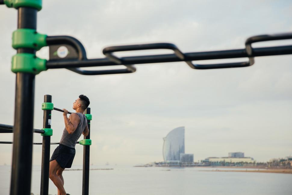 Free Image of A young Asian man doing chin-up exercise 