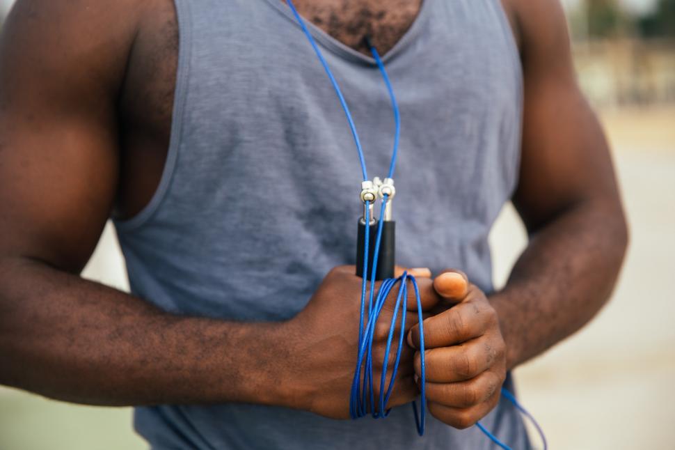 Free Image of A young African man holding exercise gear 