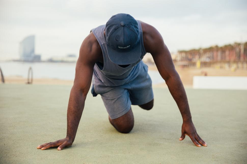 Free Image of A young African man stretching outdoors 