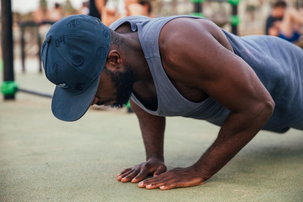 Free Image of A young African man doing push-up exercise outdoors 