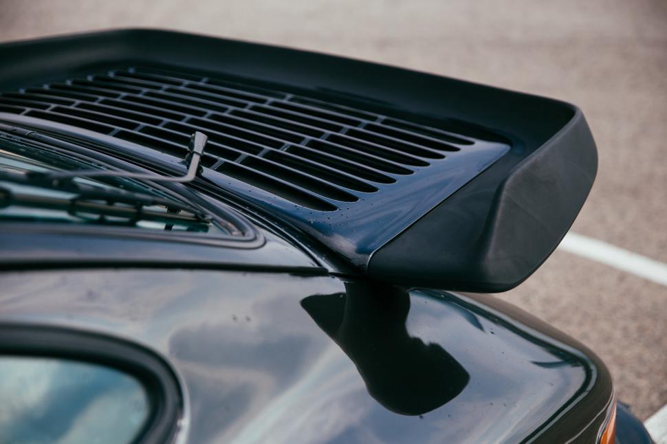 Free Image of Side view of a black sports car spoiler 