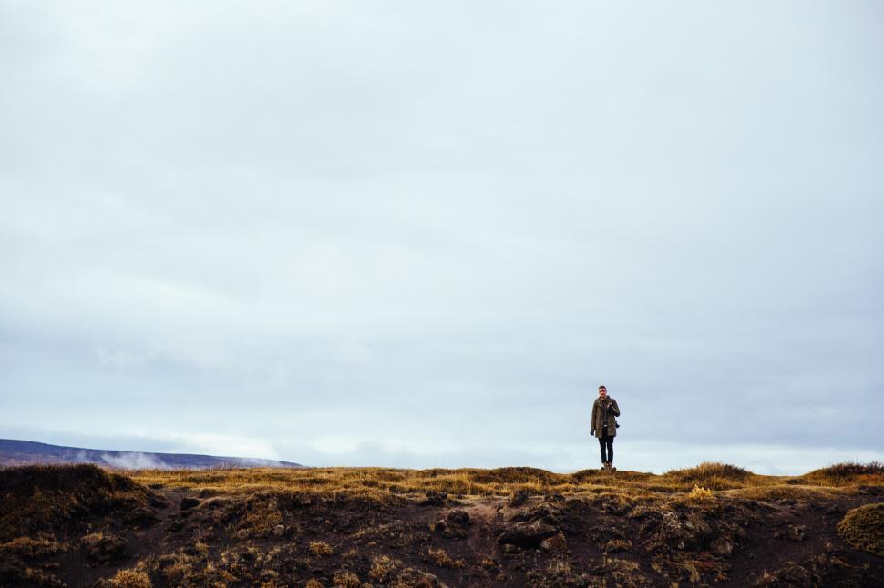 Free Image of A hiker stops near a rockey edge 