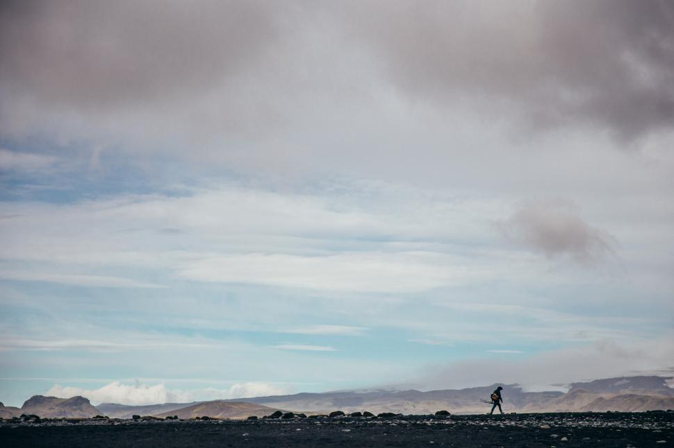 Free Image of A photographer hiking in Iceland volcanic landscape 