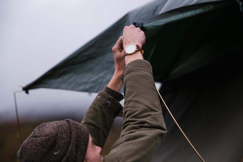 Free Image of A young caucasian man setting up tent 