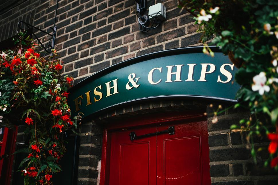 Free Image of Fish and chips sign at a restaurant entrance 