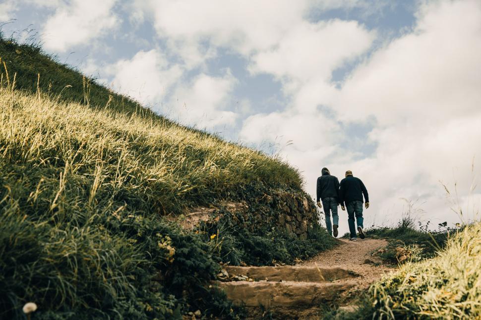 Download Free Stock Photo of Men hiking on grassy hills 