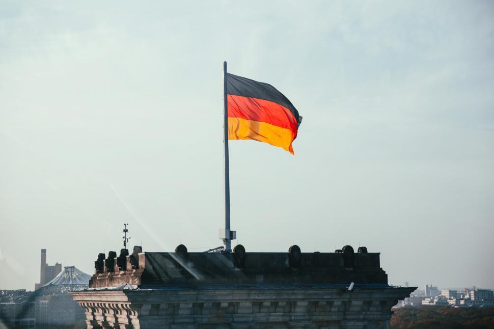 Free Image of German flag fluttering on a rooftop 