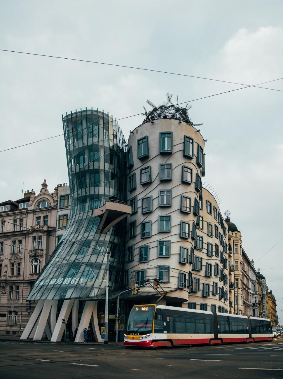 Free Image of Dancing House in Prague with Train 