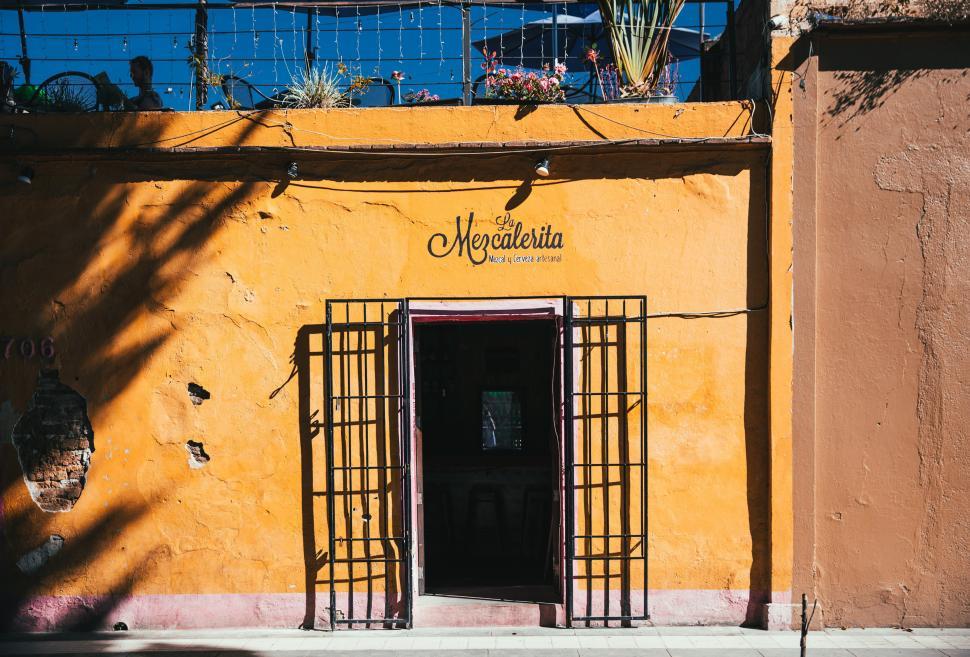 Free Image of Entrance of a tropical bar with yellow exterior 