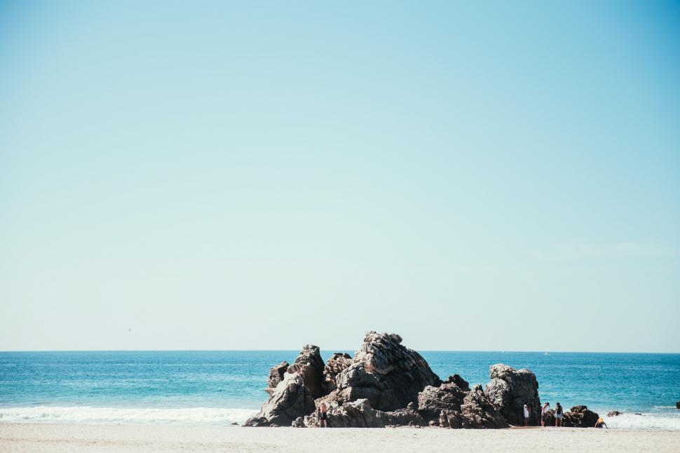 Free Image of A rocky seashore in sunlight 