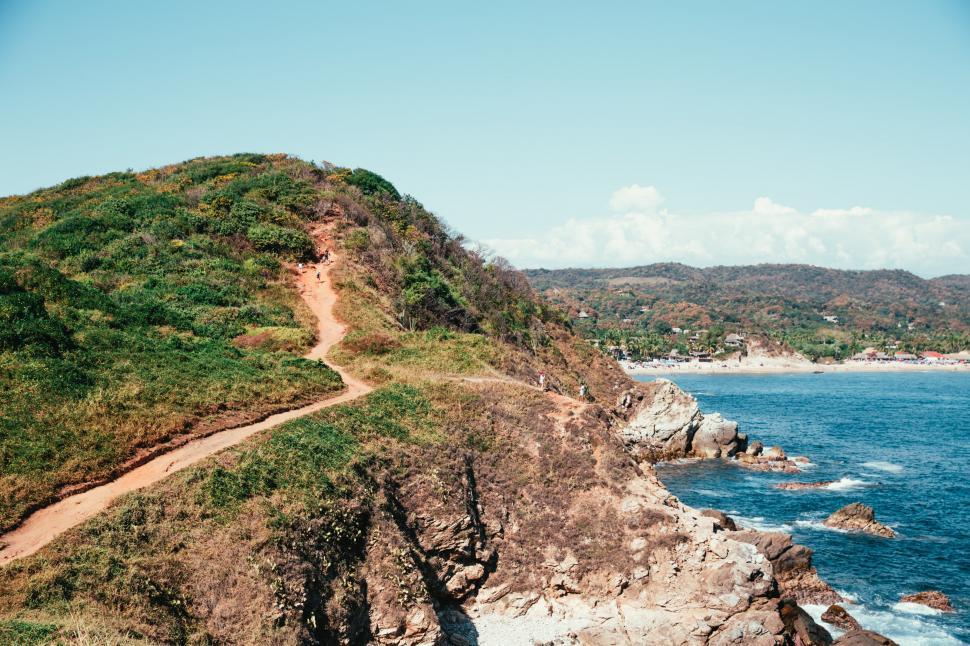 Free Image of Hikers on the seaside mountain path 