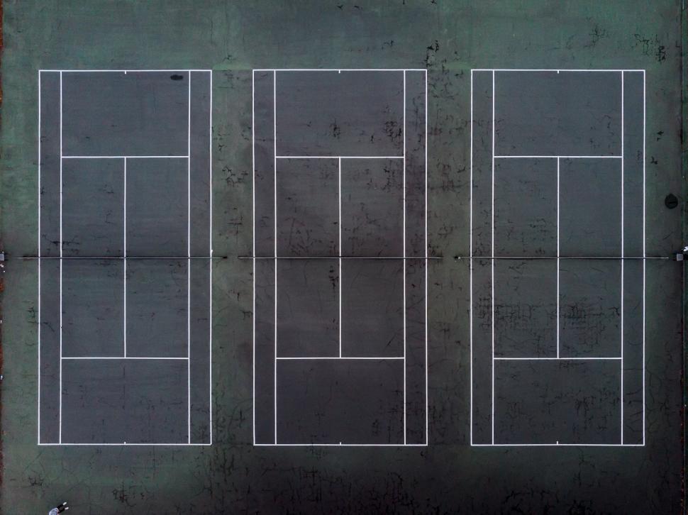 Free Image of Aerial view of three tennis courts 