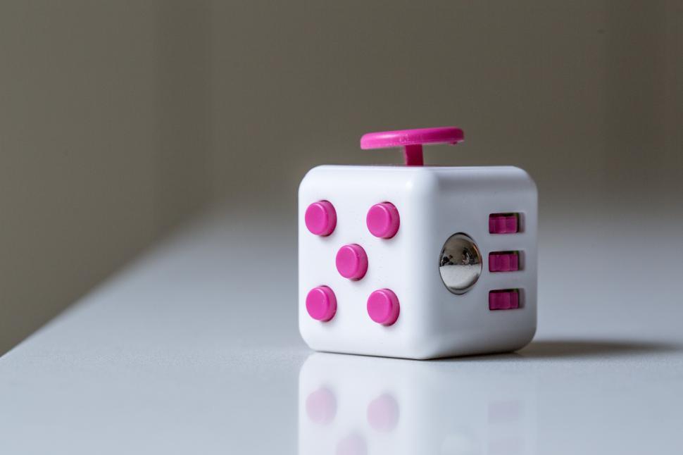 Free Image of Close up of pink and white fidget cube 