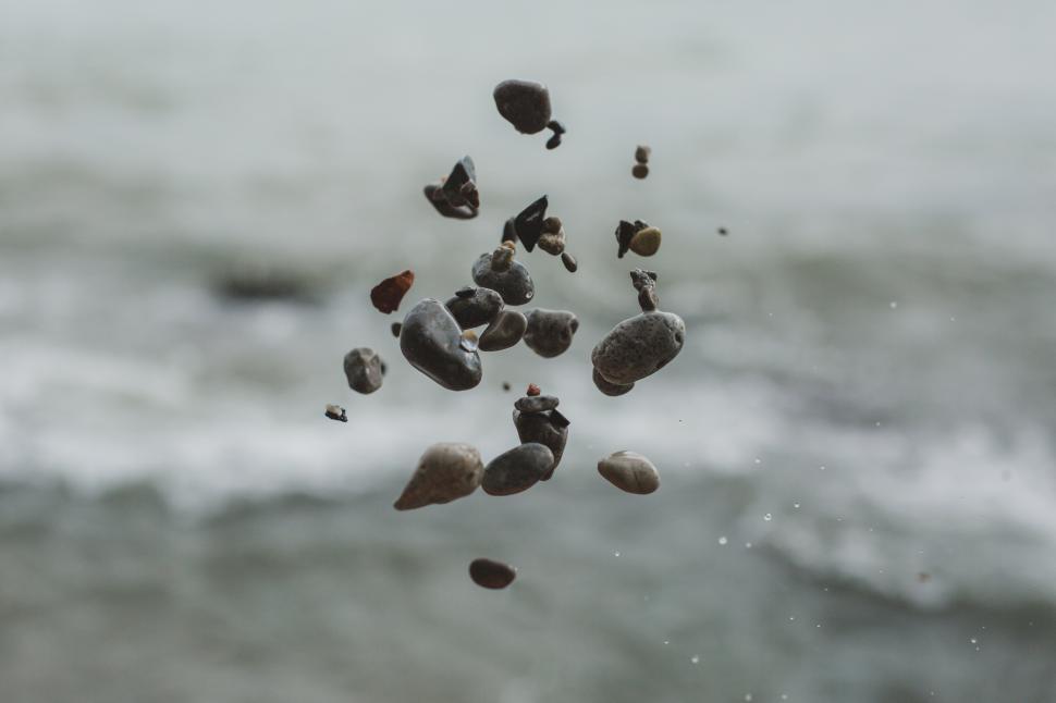 Free Image of Close up of pebble stones floating in the air 