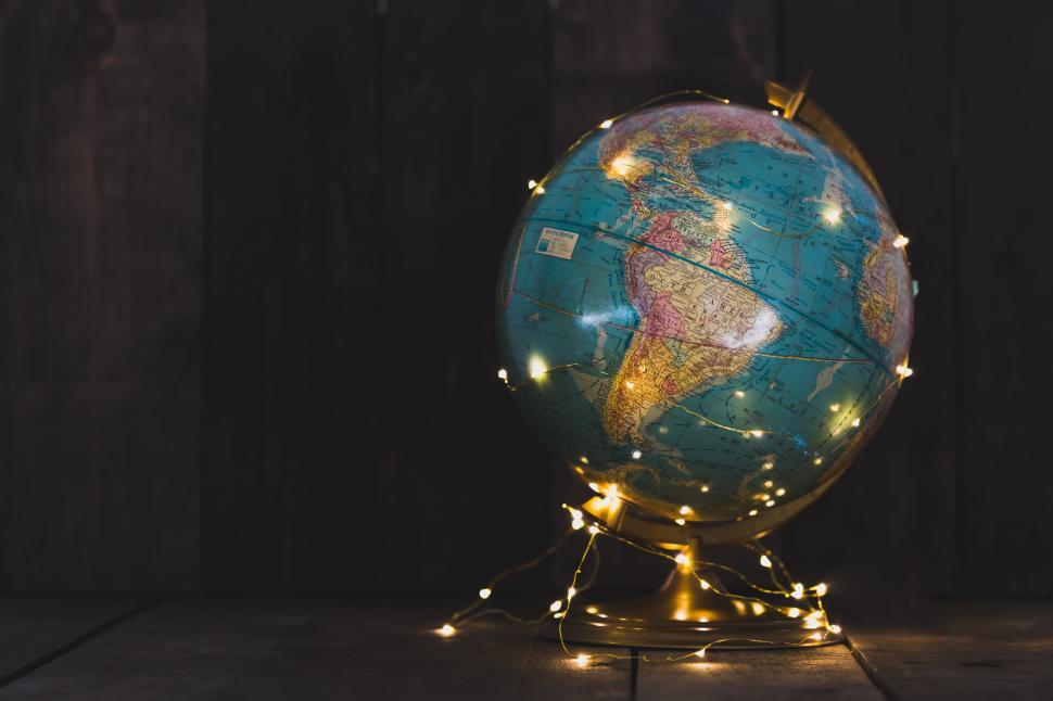 Download Free Stock Photo of A globe with a string of lights wrapped around it 