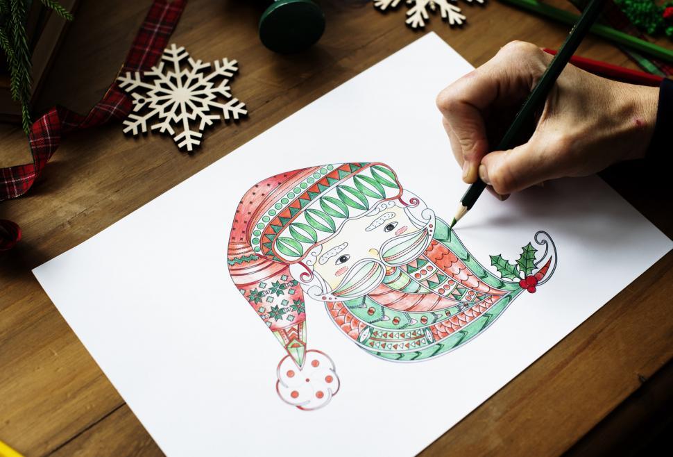 Free Image of Close up of Santa Claus picture being colored with a pencil 