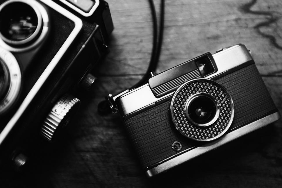 Free Image of Back and white flat lay of two vintage photo cameras 
