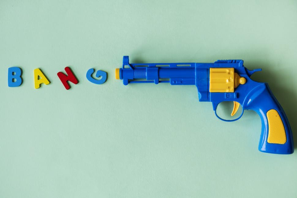 Free Image of Flat lay of the text BANG depicted as being fired from a toy gun 