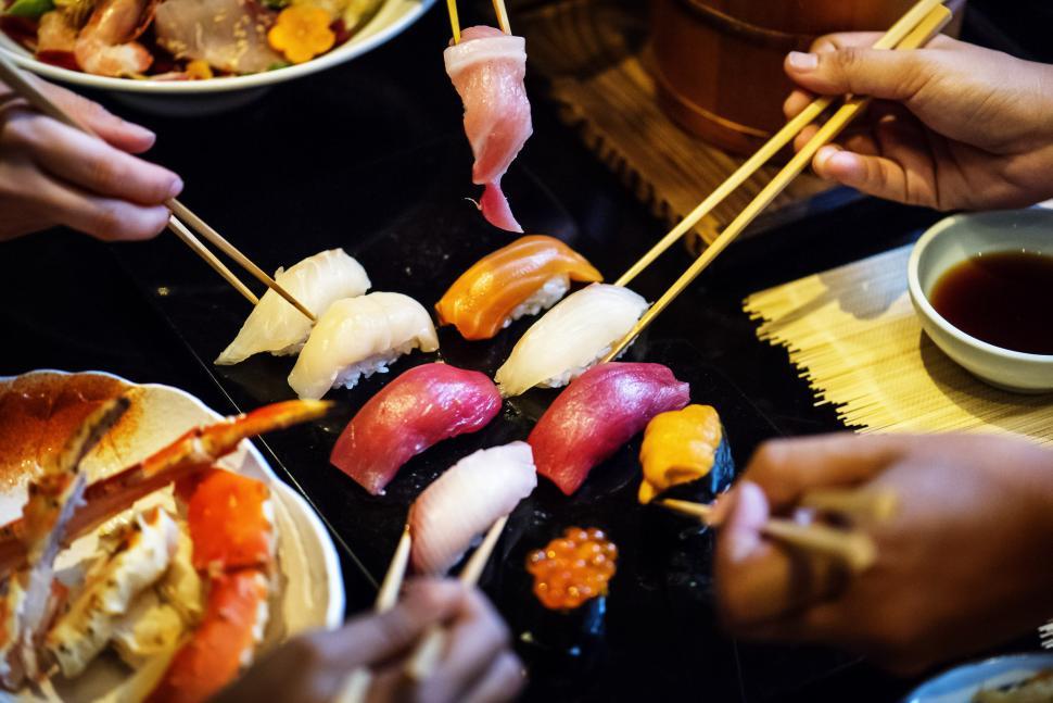 Free Image of Close up of sea food being picked with chopsticks 