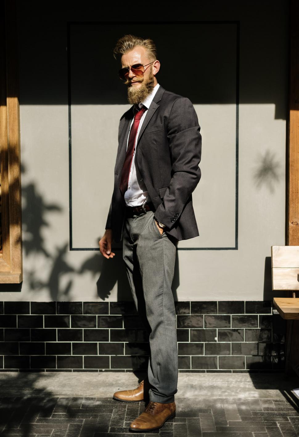 Free Image of A bearded man posing with his hand in his trouser s pocket 