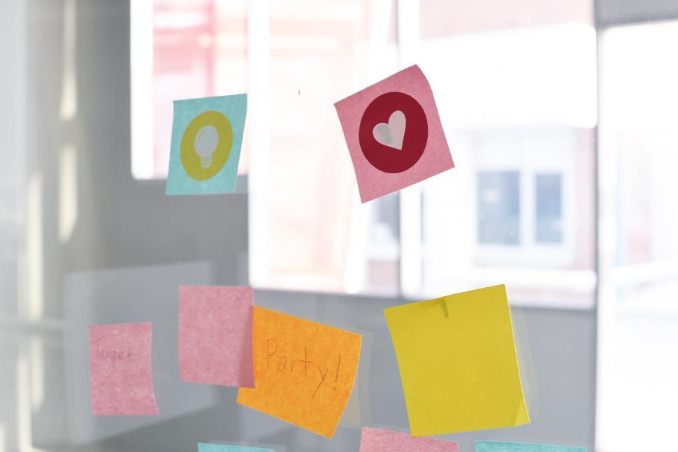 Free Image of Sticky notes on a glass wall in the office 