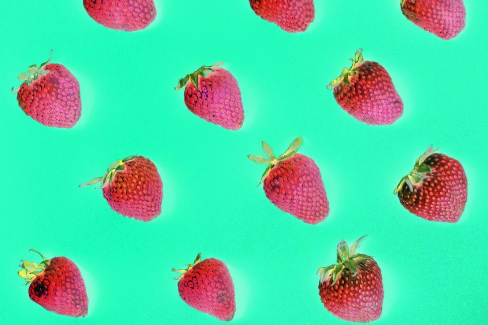 Free Image of Flay lay of strawberries on green surface 