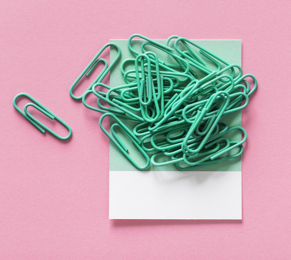 Free Image of Green paperclips on pink surface 