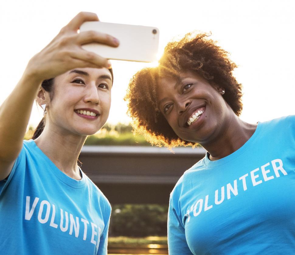 Free Image of Two young multiethnicity female volunteers taking a selfie 
