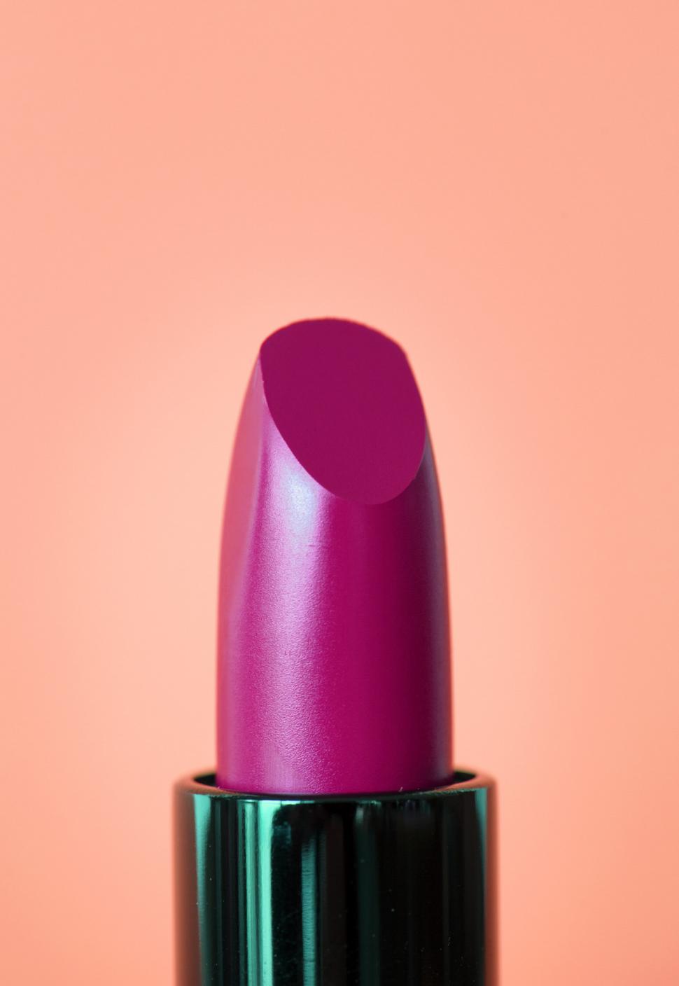 Free Image of Close up of bright magenta twisted up lipstick 