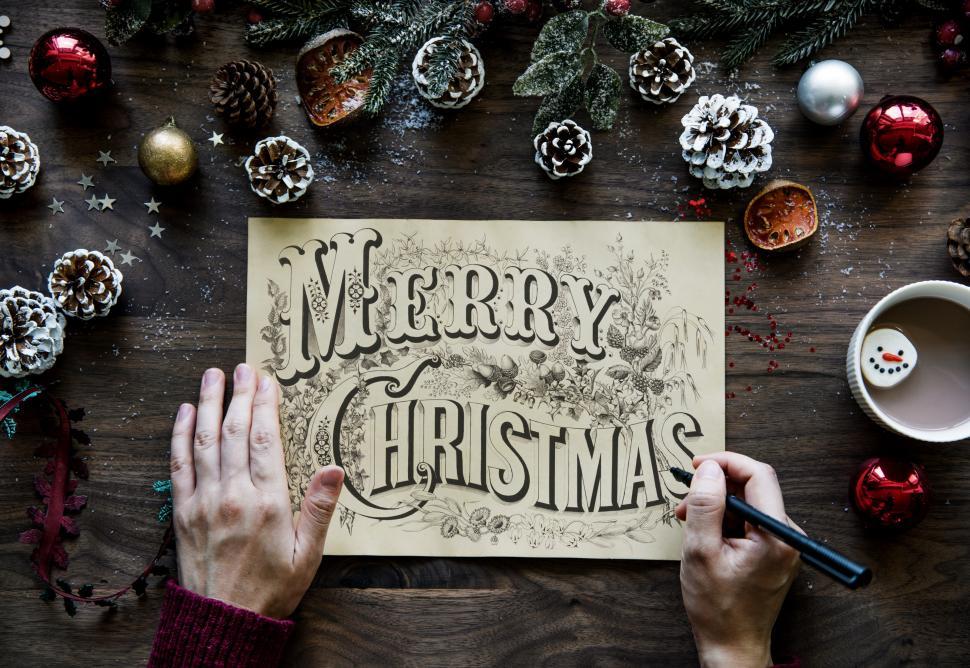 Free Image of Close up of Merry Christmas calligraphy surrounded with Christma 