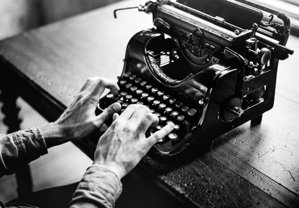 Free Image of Black and white photo of hands typing on an antique typewriter Abstract Colorful Pattern - Squares and Rectangles 