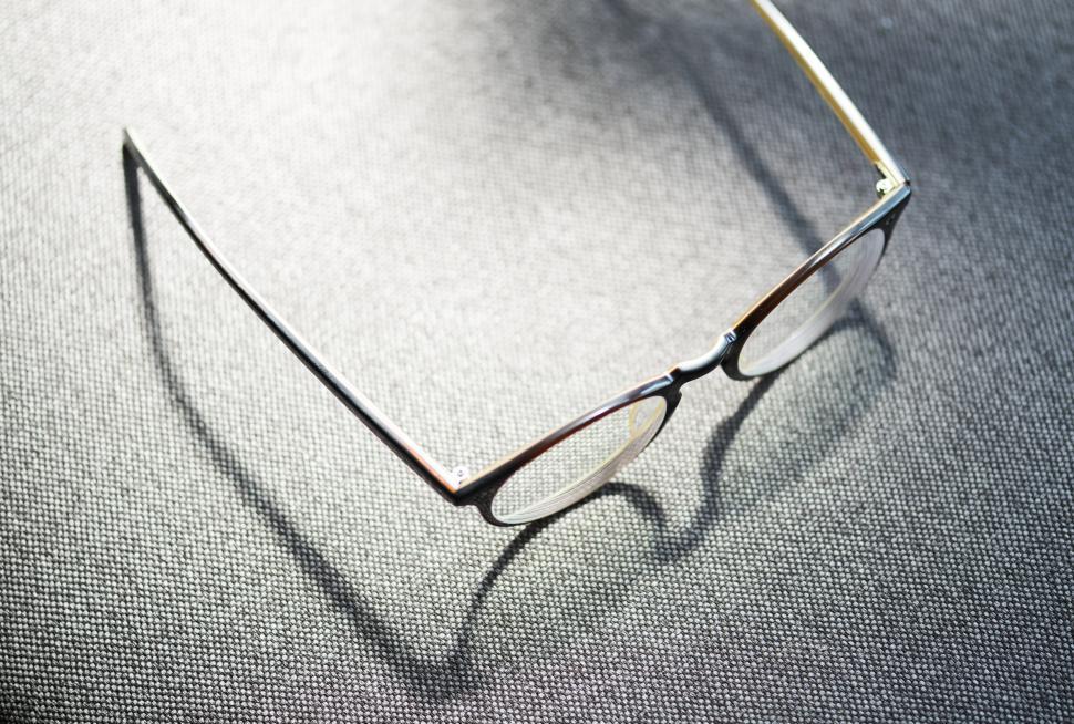 Free Image of Close up spectacles on grey fabric 