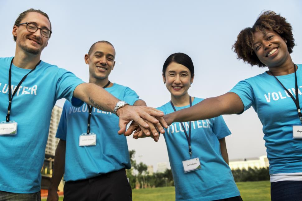 Free Image of Multiethnicity volunteers with hands their stacked together in a huddle 