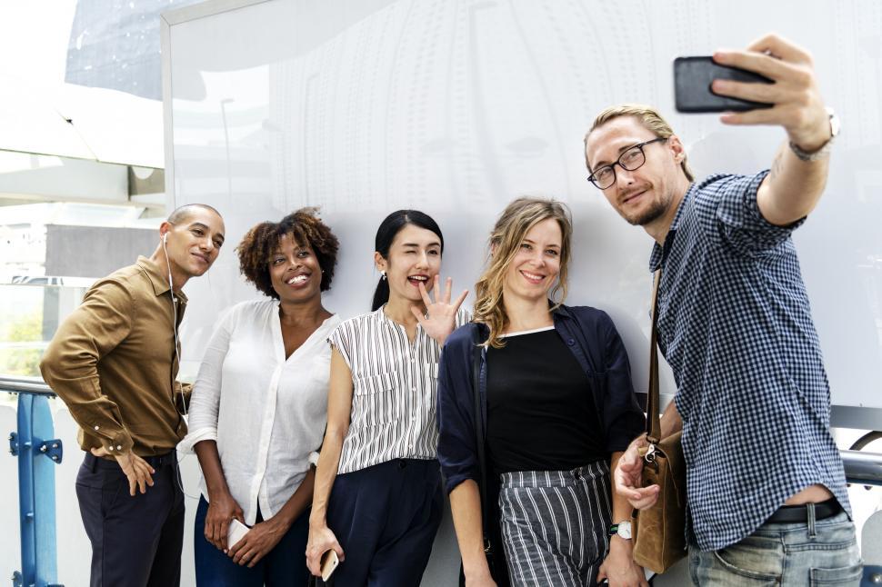 Free Image of Multiethnicity people taking a group photo with mobile phone 