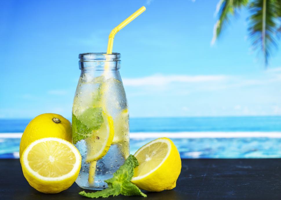 Free Image of Close up of chilled lemonade in a bottle with yellow straw 