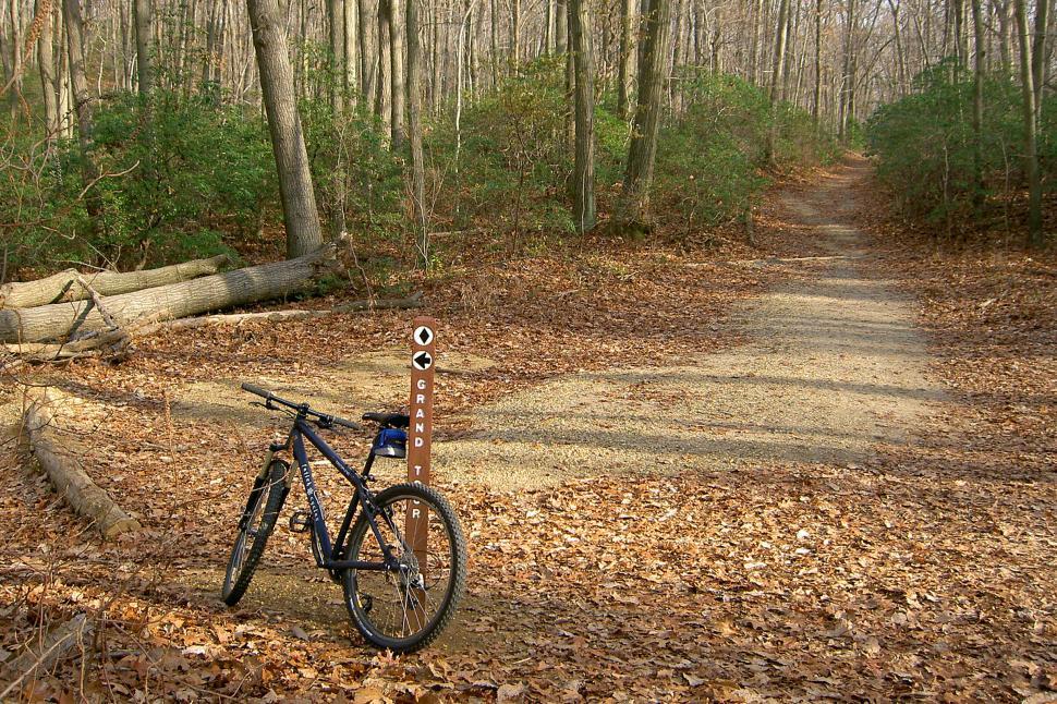 Free Image of Mountain Bikes By A Trail Marker 
